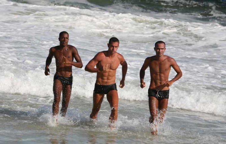 ATYM6R Three gorgeous sexy handsome muscular fit athletic lifeguards, Copacabana beach, Rio de Janeiro, Brazil, South America. Image shot 2007. Exact date unknown.